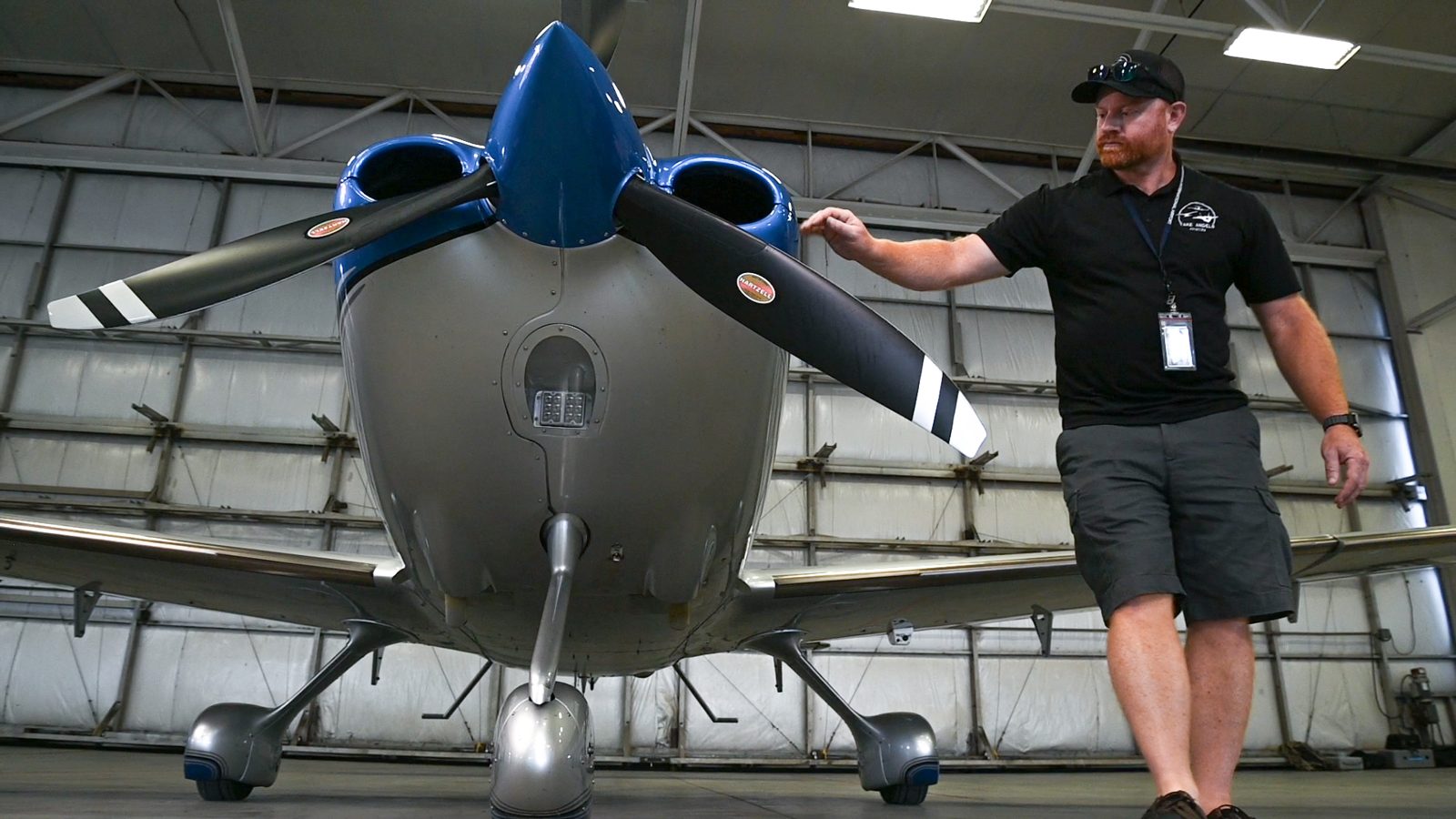Matt Walldroff walking the propeller during a preflight inspection of a Cirrus in the Take Angels hangar